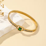 Gold bracelet with a green gemston
