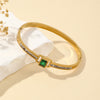 Gold bracelet with a green gemston